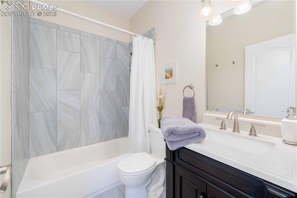 15721 South Furrow Road Larkspur, CO 80118 - Photo 35 of 50 a bathroom with a sink toilet and shower