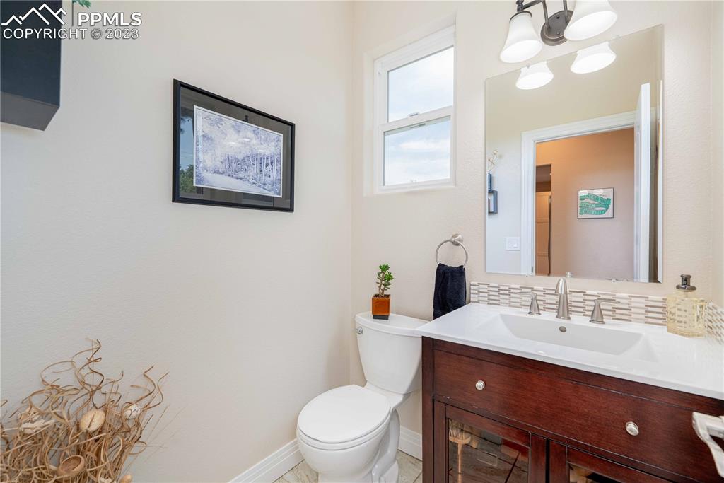 15721 South Furrow Road Larkspur, CO 80118 - Photo 36 of 50 a bathroom with a toilet a sink a mirror and a shower