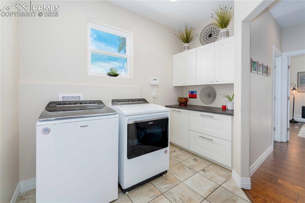 15721 South Furrow Road Larkspur, CO 80118 - Photo 37 of 50 a kitchen with a stove and white cabinets