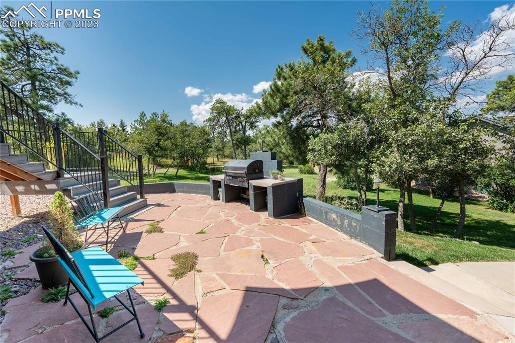 15721 South Furrow Road Larkspur, CO 80118 - Photo 41 of 50 a view of a backyard with sitting area