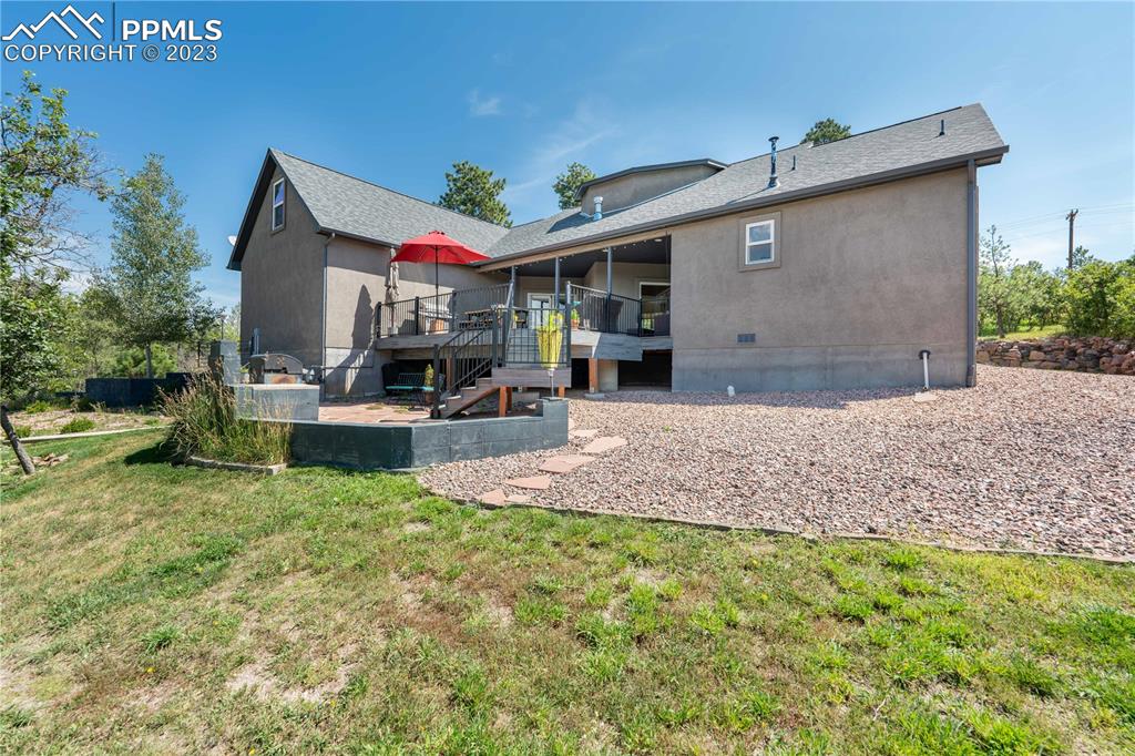 15721 South Furrow Road Larkspur, CO 80118 - Photo 42 of 50 a front view of a house with a yard and garage