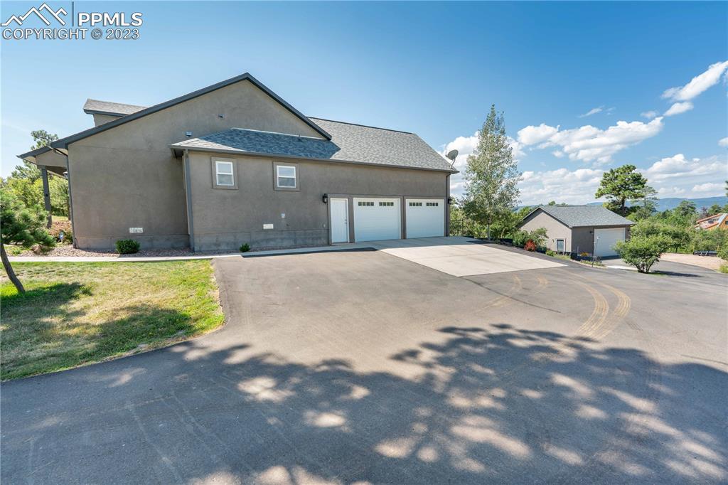 15721 South Furrow Road Larkspur, CO 80118 - Photo 49 of 50 a front view of a house with a yard and garage