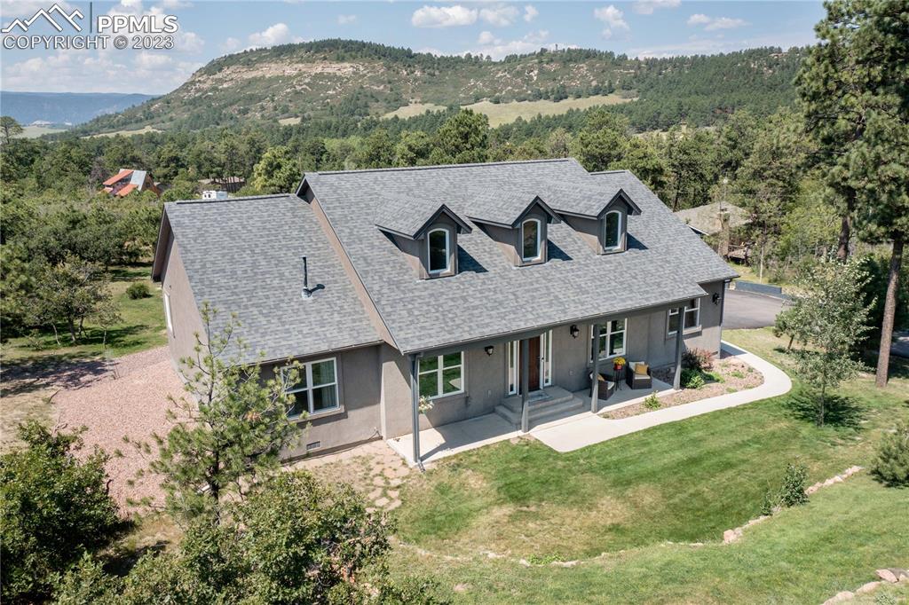 15721 South Furrow Road Larkspur, CO 80118 - Photo 50 of 50 a aerial view of a house with table and chairs under an umbrella