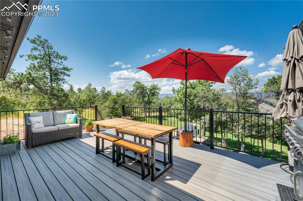 15721 South Furrow Road Larkspur, CO 80118 - Photo 5 of 50 a view of a balcony with chairs and wooden floor