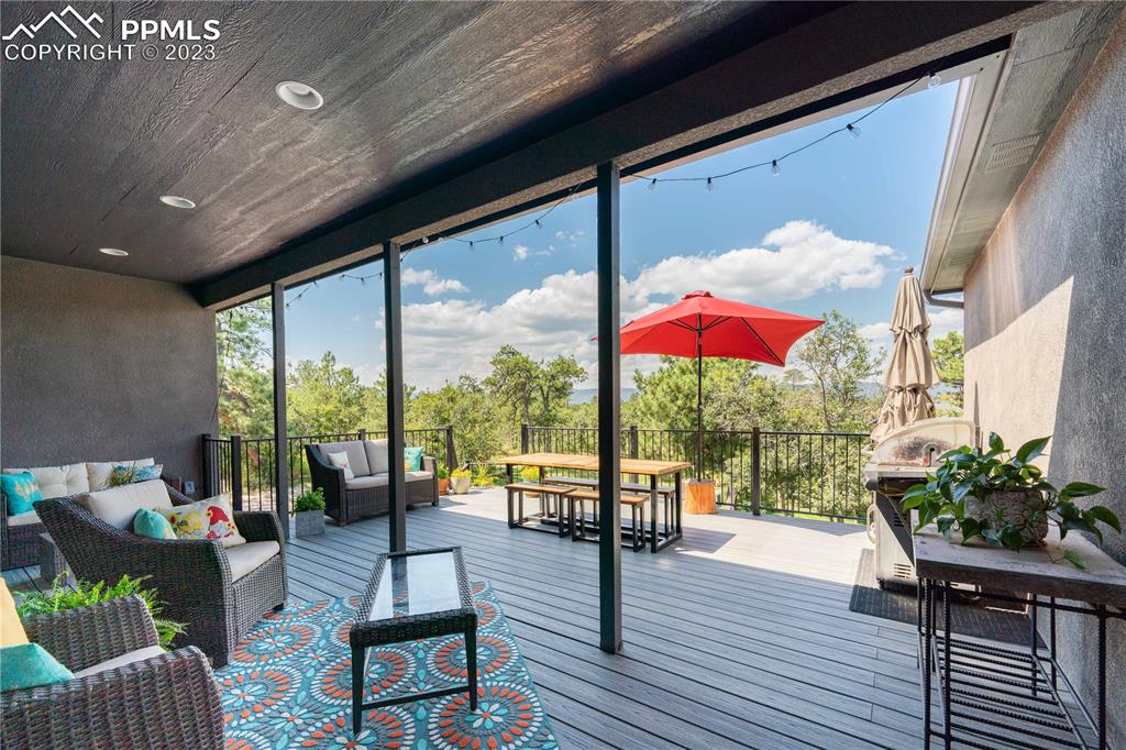 15721 South Furrow Road Larkspur, CO 80118 - Photo 8 of 50 a living room with furniture and a large window
