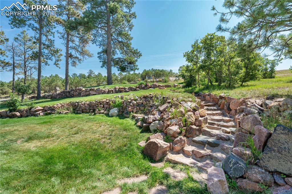 15721 South Furrow Road Larkspur, CO 80118 - Photo 10 of 50 a view of a garden with a lake view