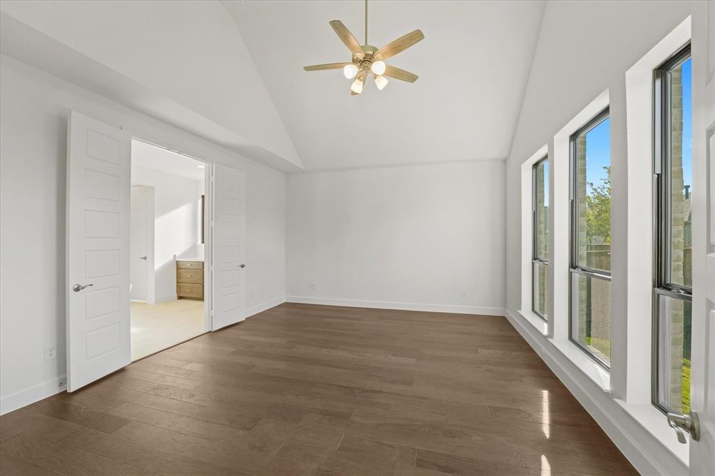 4626 Rillstone Road Midlothian, TX 76065 - Photo 13 of 40 Unfurnished room featuring high vaulted ceiling, dark wood-type flooring, and a ceiling fan