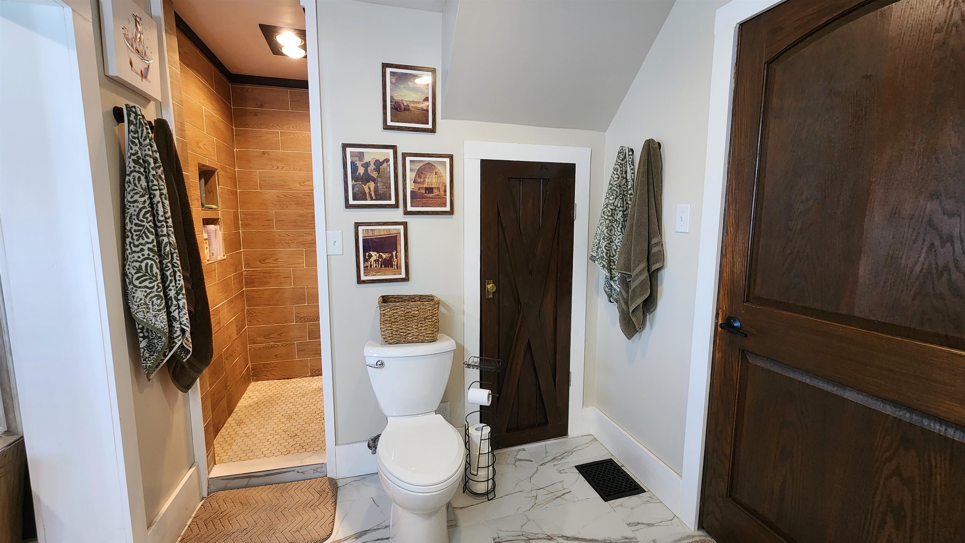8999 Centerville Road Capron, IL 61012 - Photo 26 of 69 a white toilet sitting next to a bathroom sink and a shower