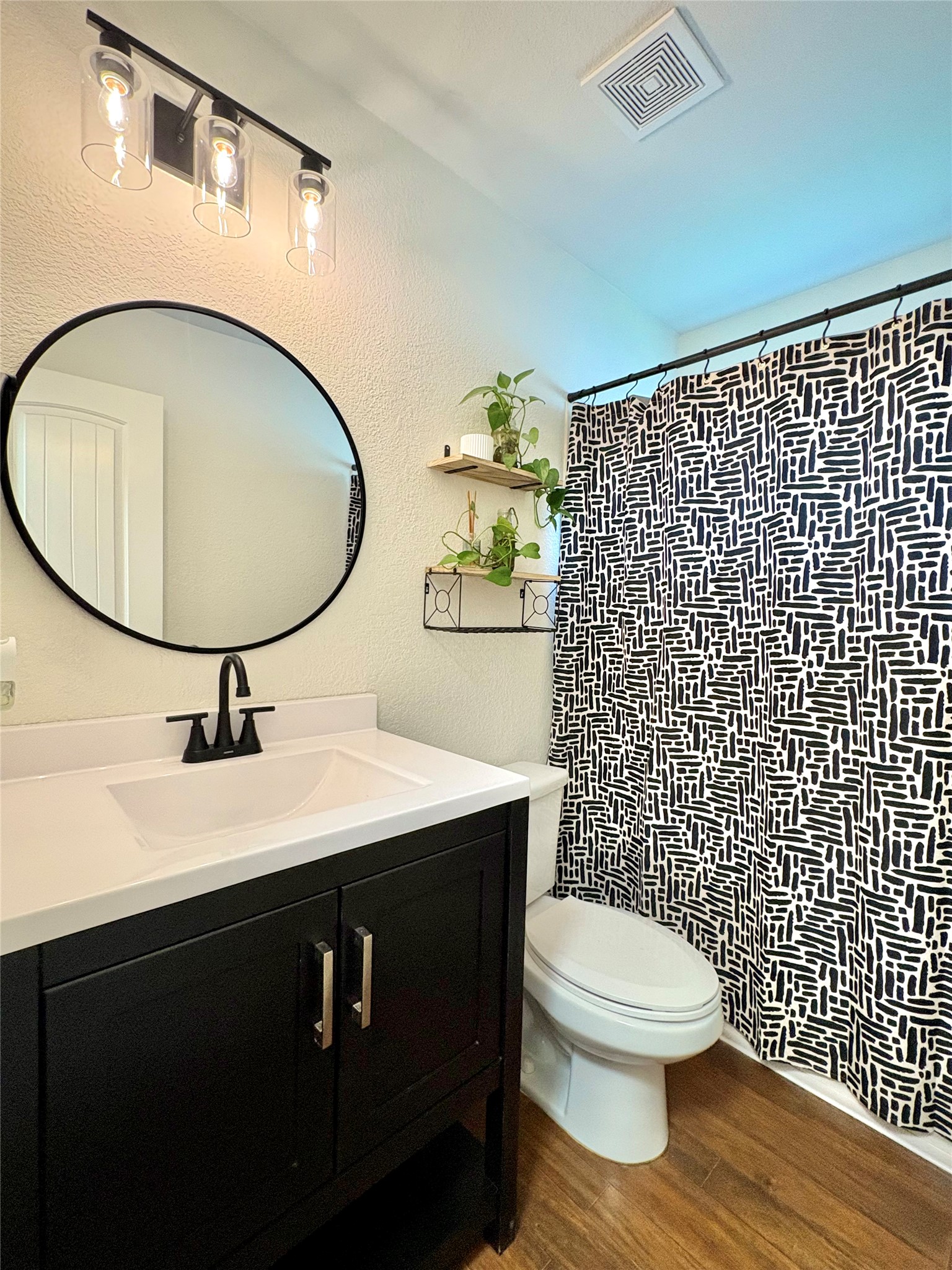 606 Old Peak Road Georgetown, TX 78626 - Photo 13 of 16 a bathroom with a sink toilet mirror and shower
