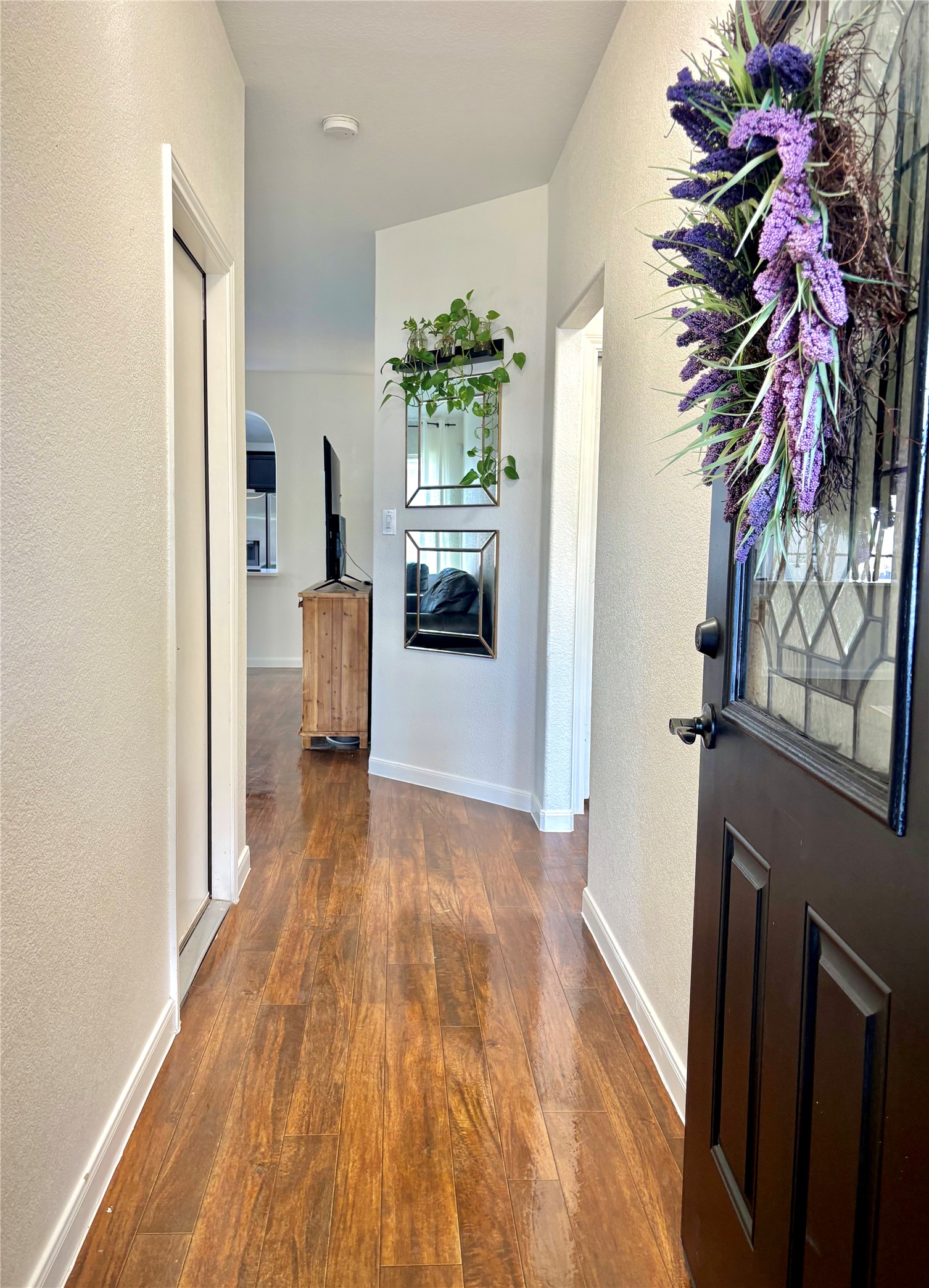 606 Old Peak Road Georgetown, TX 78626 - Photo 4 of 16 a view of a hallway with wooden floor and a potted plant