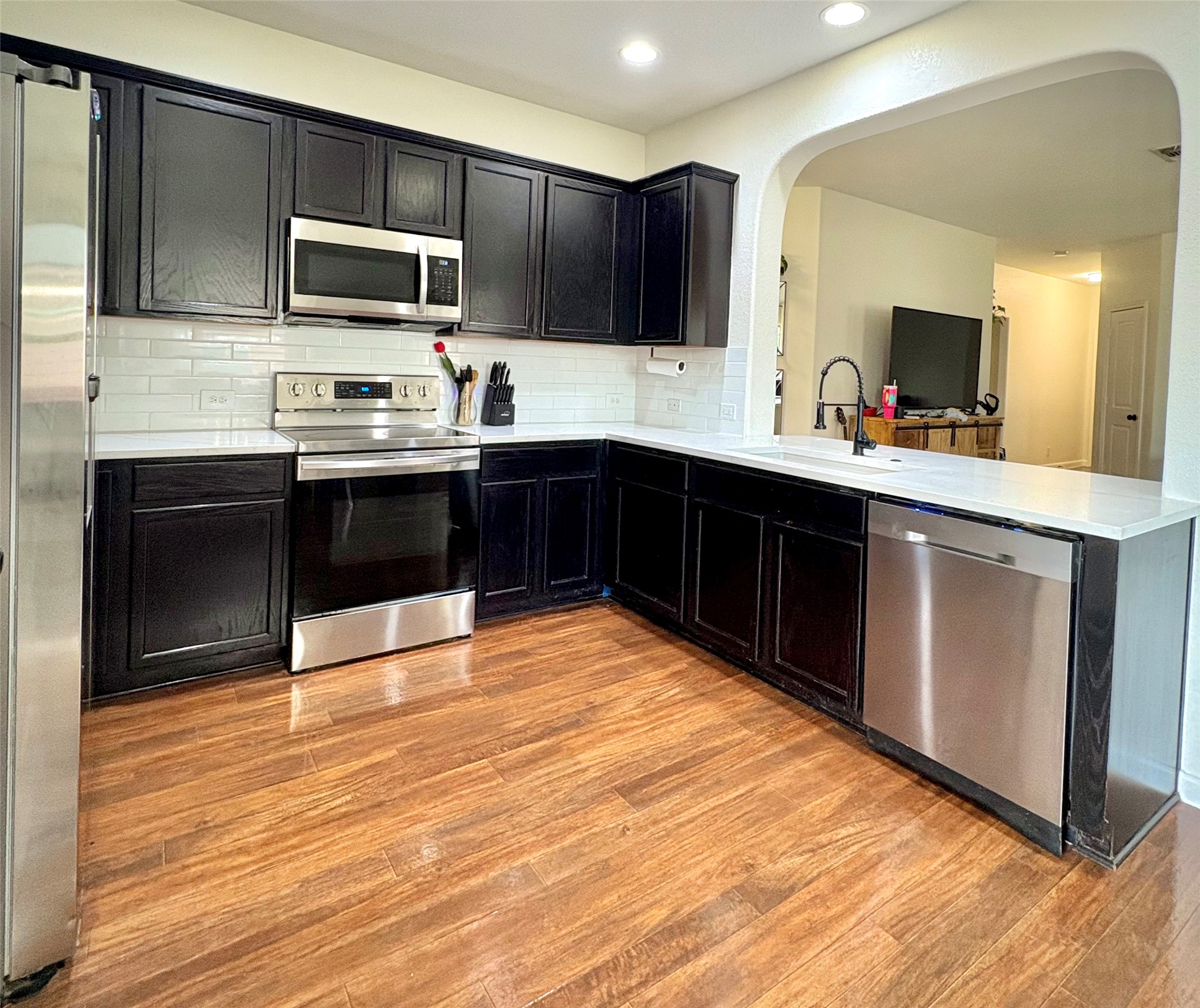 606 Old Peak Road Georgetown, TX 78626 - Photo 5 of 16 a kitchen with stainless steel appliances kitchen island granite countertop a stove top oven and sink