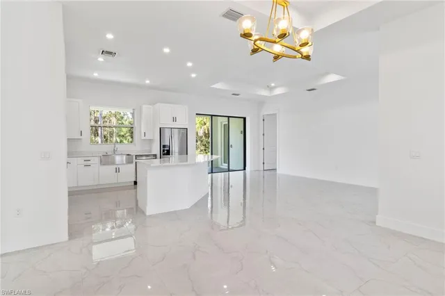a view of kitchen with refrigerator and window