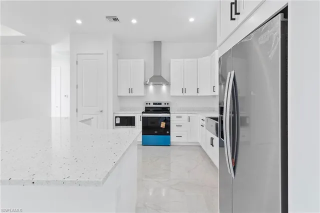 a kitchen with stainless steel appliances a refrigerator and a stove