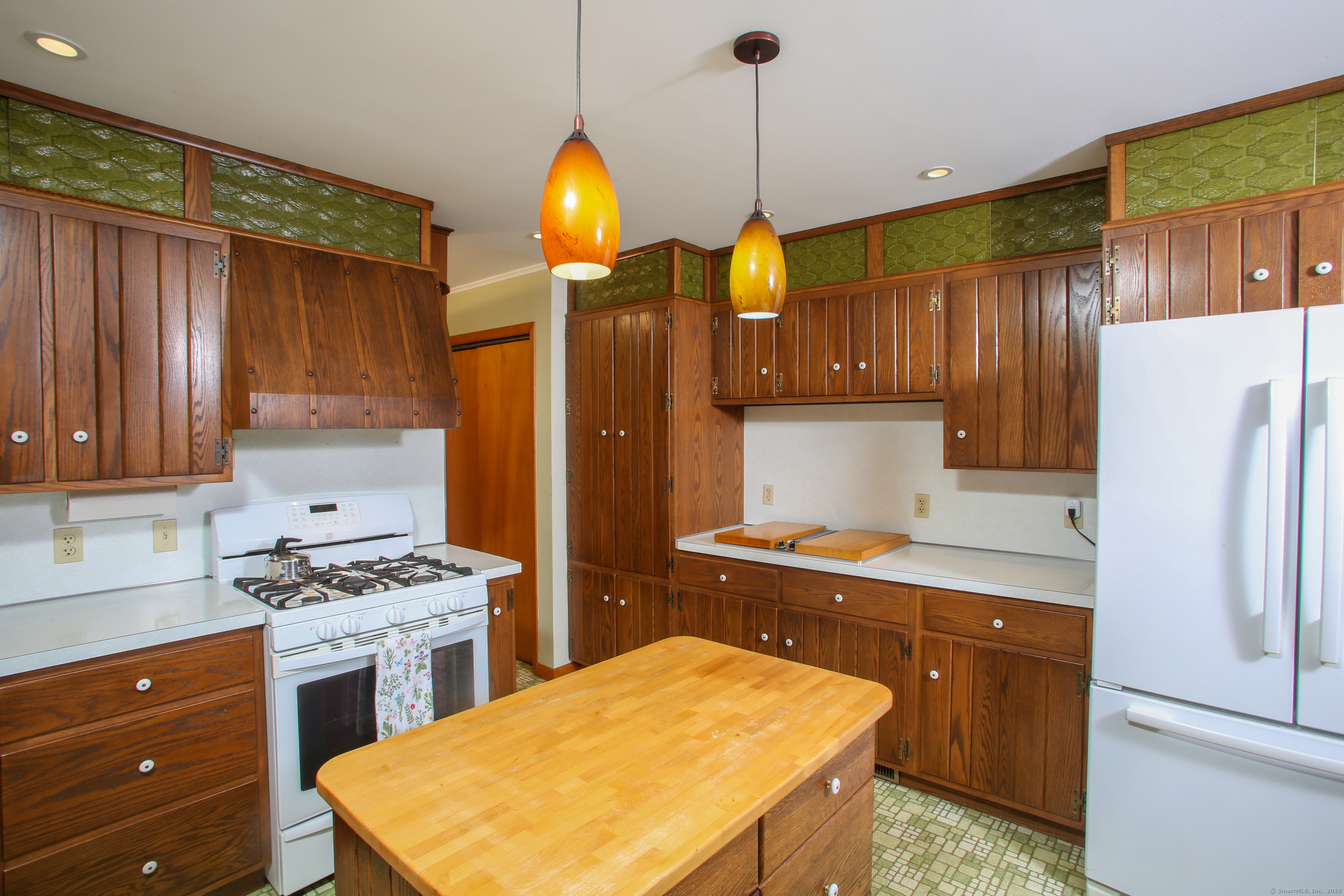 76 Fairchild Road Sharon, CT 06069 - Photo 7 of 39 a kitchen with a refrigerator a sink and wooden cabinets