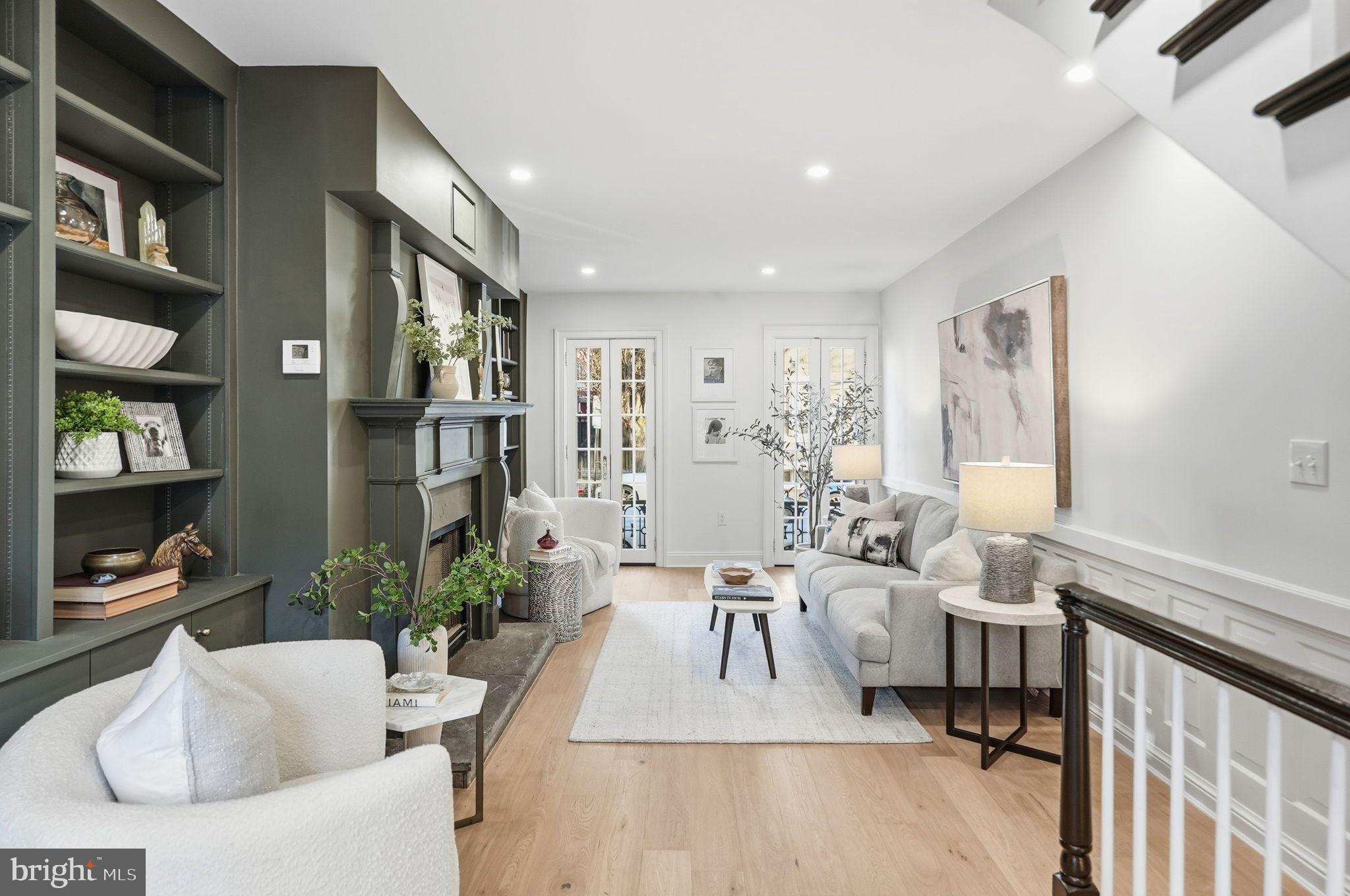 a living room with furniture and a book shelf