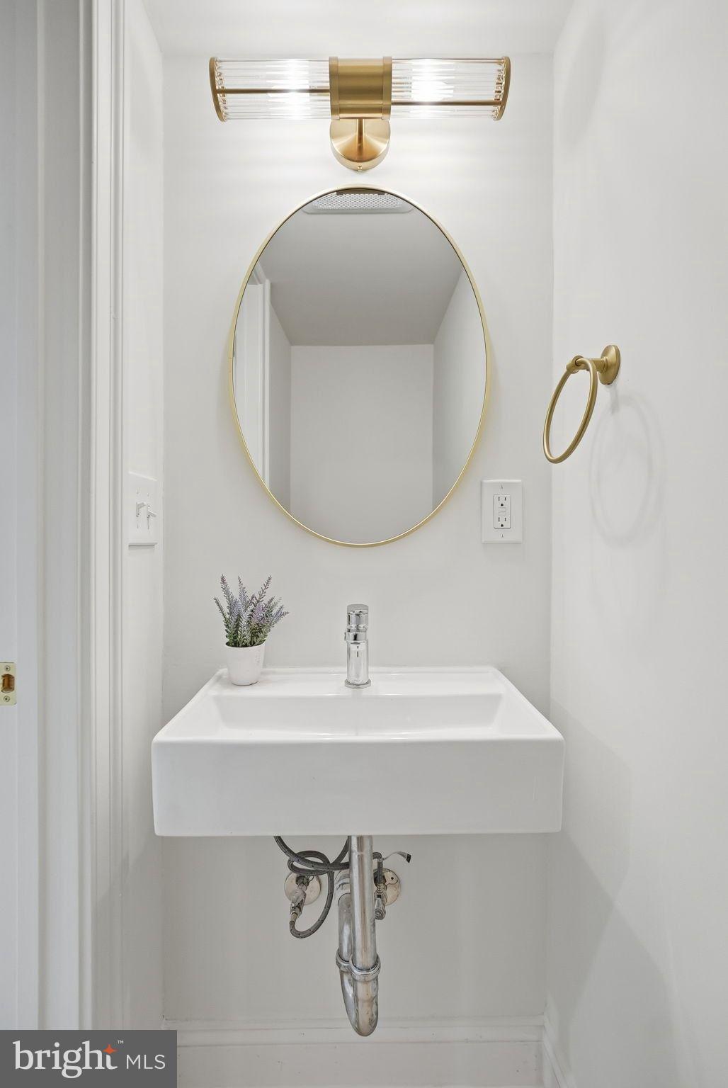 1608 33rd Street Northwest Washington, DC 20007 - Photo 14 of 16 a bathroom with a sink and a mirror