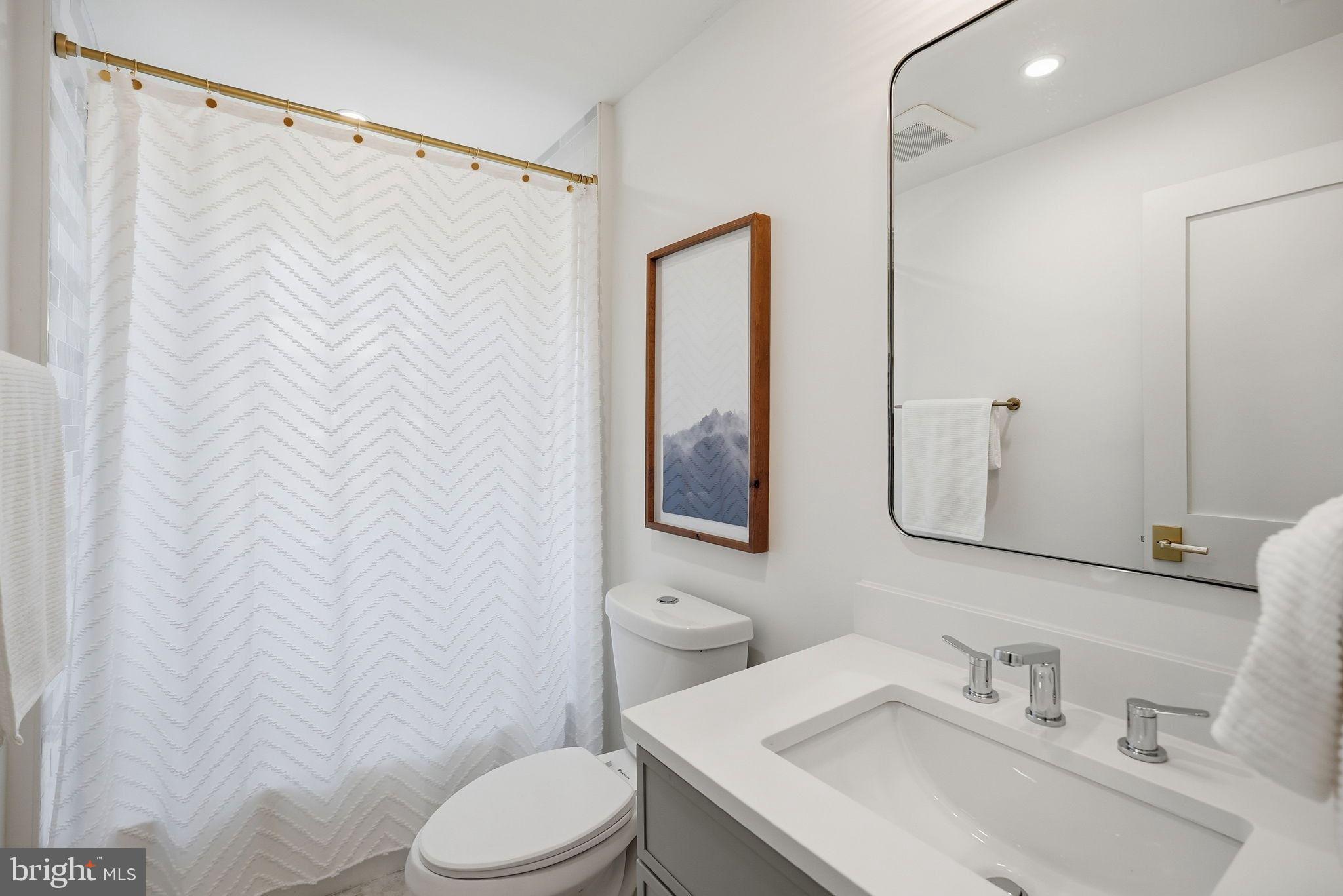 1608 33rd Street Northwest Washington, DC 20007 - Photo 14 of 16 a bathroom with a sink and a mirror