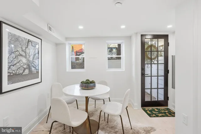 a dining room with furniture and window