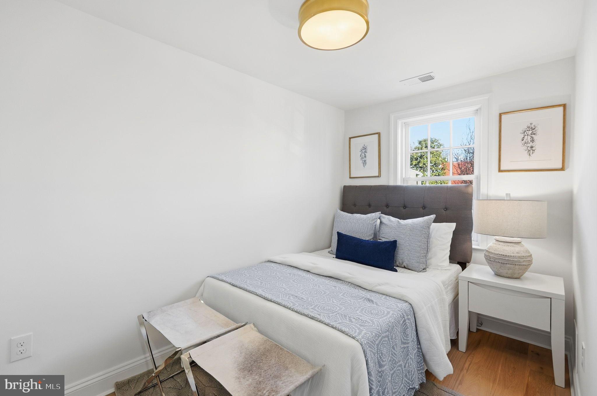 1608 33rd Street Northwest Washington, DC 20007 - Photo 10 of 16 a bedroom with a bed and a table in it