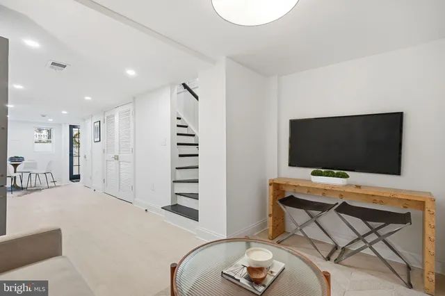 a view of a livingroom with furniture and a flat screen tv