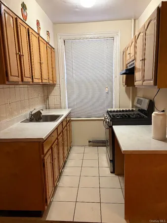 a kitchen with a sink a stove and a refrigerator