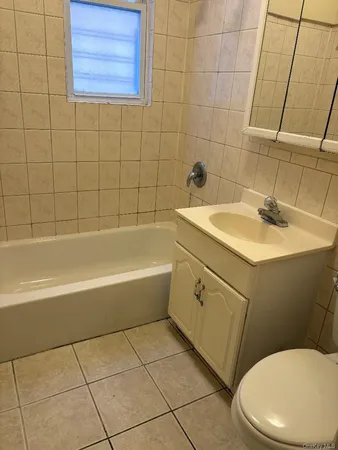 a bathroom with a sink a toilet and bathtub