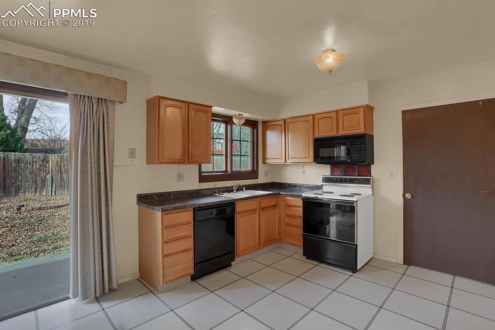 2409 Ranch Lane Colorado Springs, CO 80918 - Photo 6 of 25 Kitchen has full set of appliances and walk out to backyard.