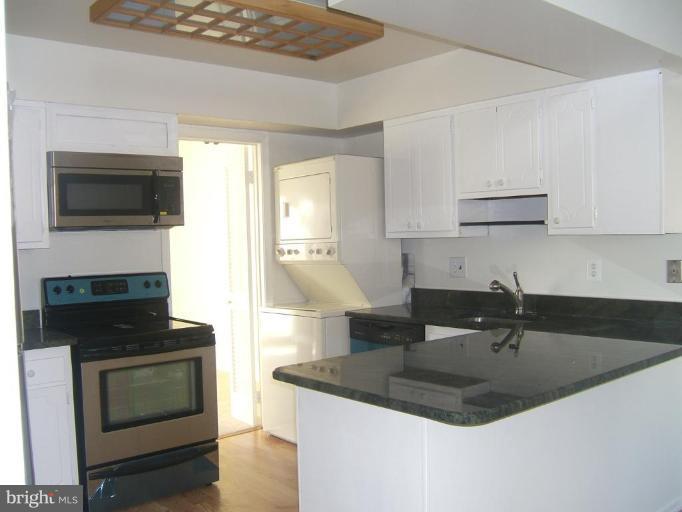 14507 Golden Oak Road Centreville, VA 20121 - Photo 2 of 12 a kitchen with granite countertop a sink a stove and cabinets