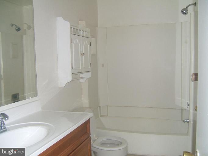 14507 Golden Oak Road Centreville, VA 20121 - Photo 6 of 12 a bathroom with a granite countertop sink toilet and shower