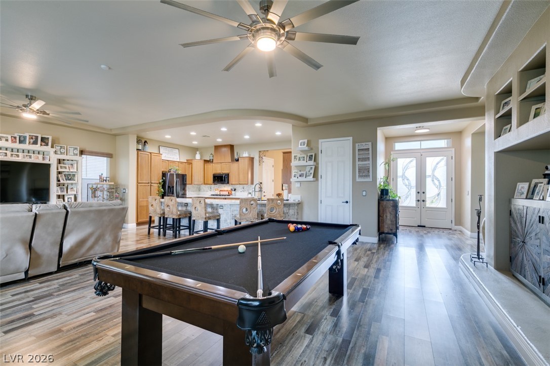 7524 Midnight Rambler Street Las Vegas, NV 89149 - Photo 12 of 51 Enter into a vast great room with durable hardwood flooring and high ceilings, ideal for entertaining.