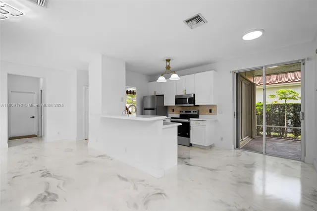 a view of a kitchen with furniture and a view