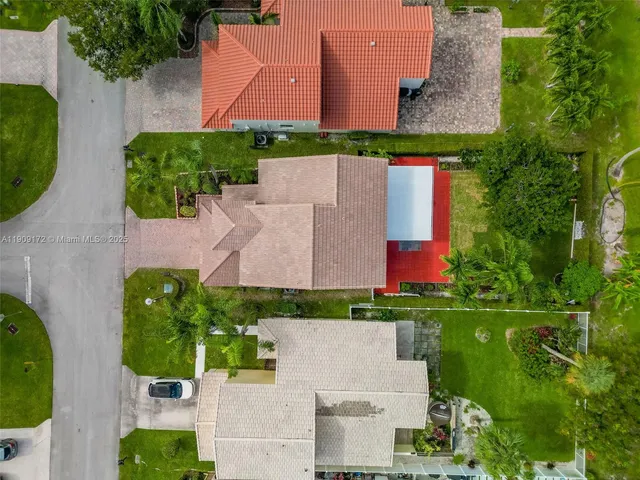 an aerial view of residential houses with outdoor space