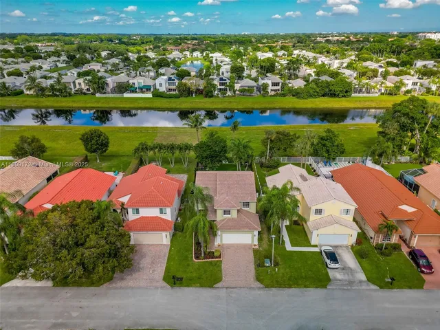 an aerial view of a house with garden space and street view