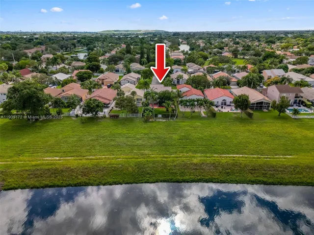 an aerial view of multiple houses with yard
