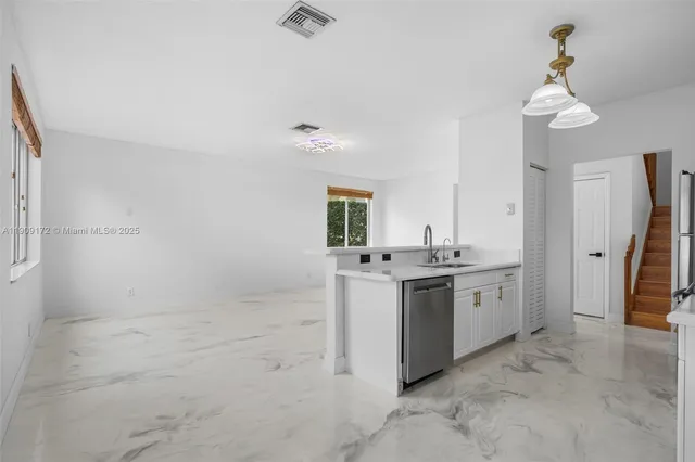 a kitchen with sink and cabinets