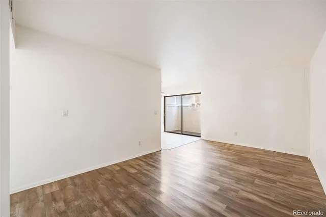 a view of an empty room and wooden floor