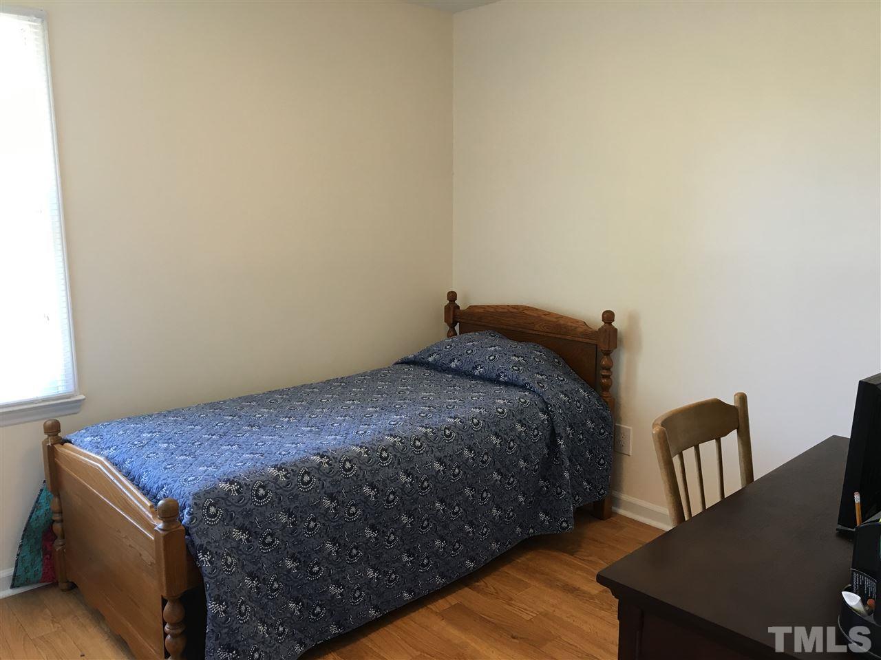 10101 Joe Leach Road Raleigh, NC 27603 - Photo 15 of 15 a bed sitting in a bedroom next to a window