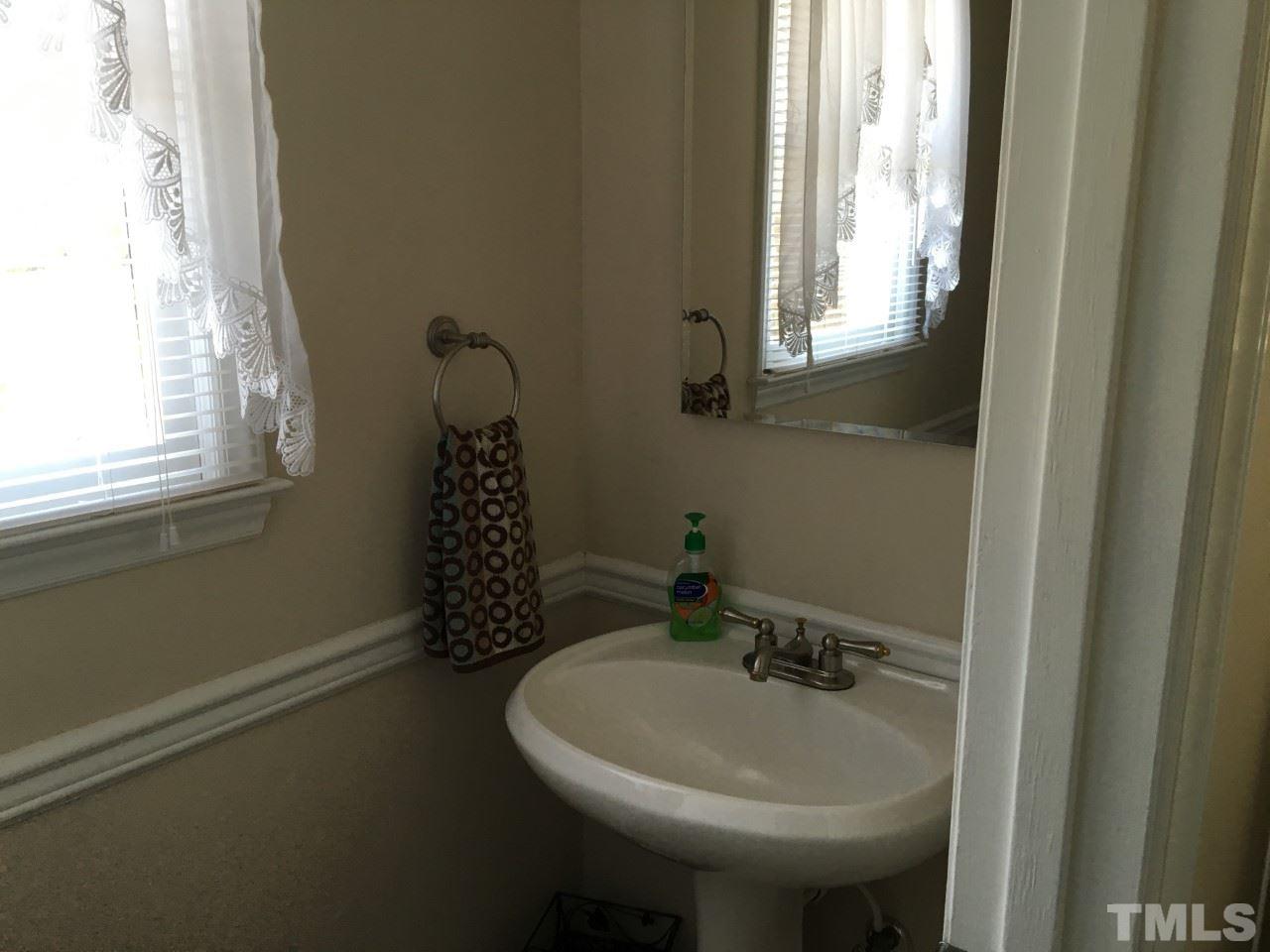 10101 Joe Leach Road Raleigh, NC 27603 - Photo 5 of 15 a bathroom with a sink a mirror and a window