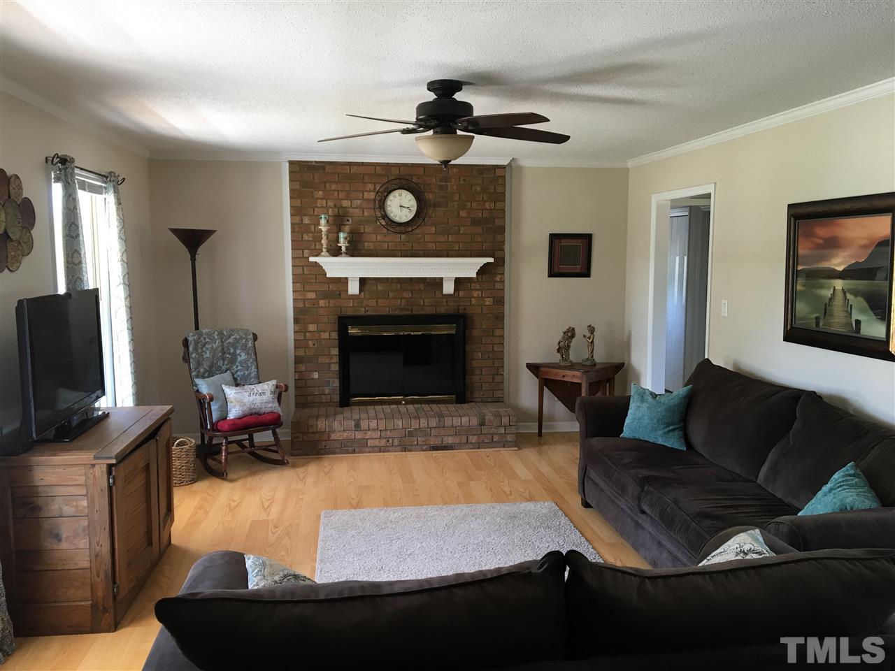 10101 Joe Leach Road Raleigh, NC 27603 - Photo 6 of 15 a living room with furniture and a fireplace