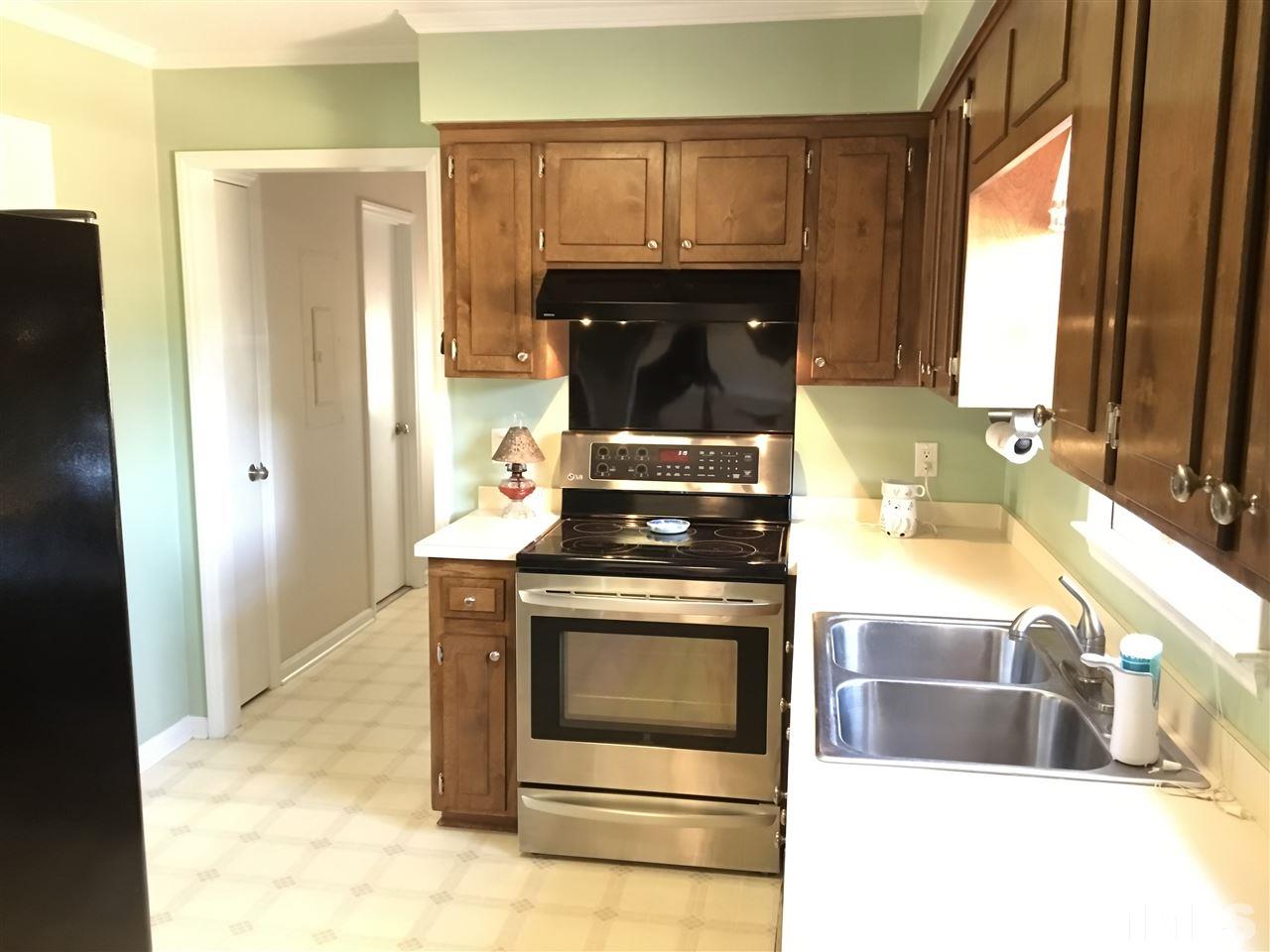 10101 Joe Leach Road Raleigh, NC 27603 - Photo 8 of 15 a kitchen with granite countertop a stove and a sink