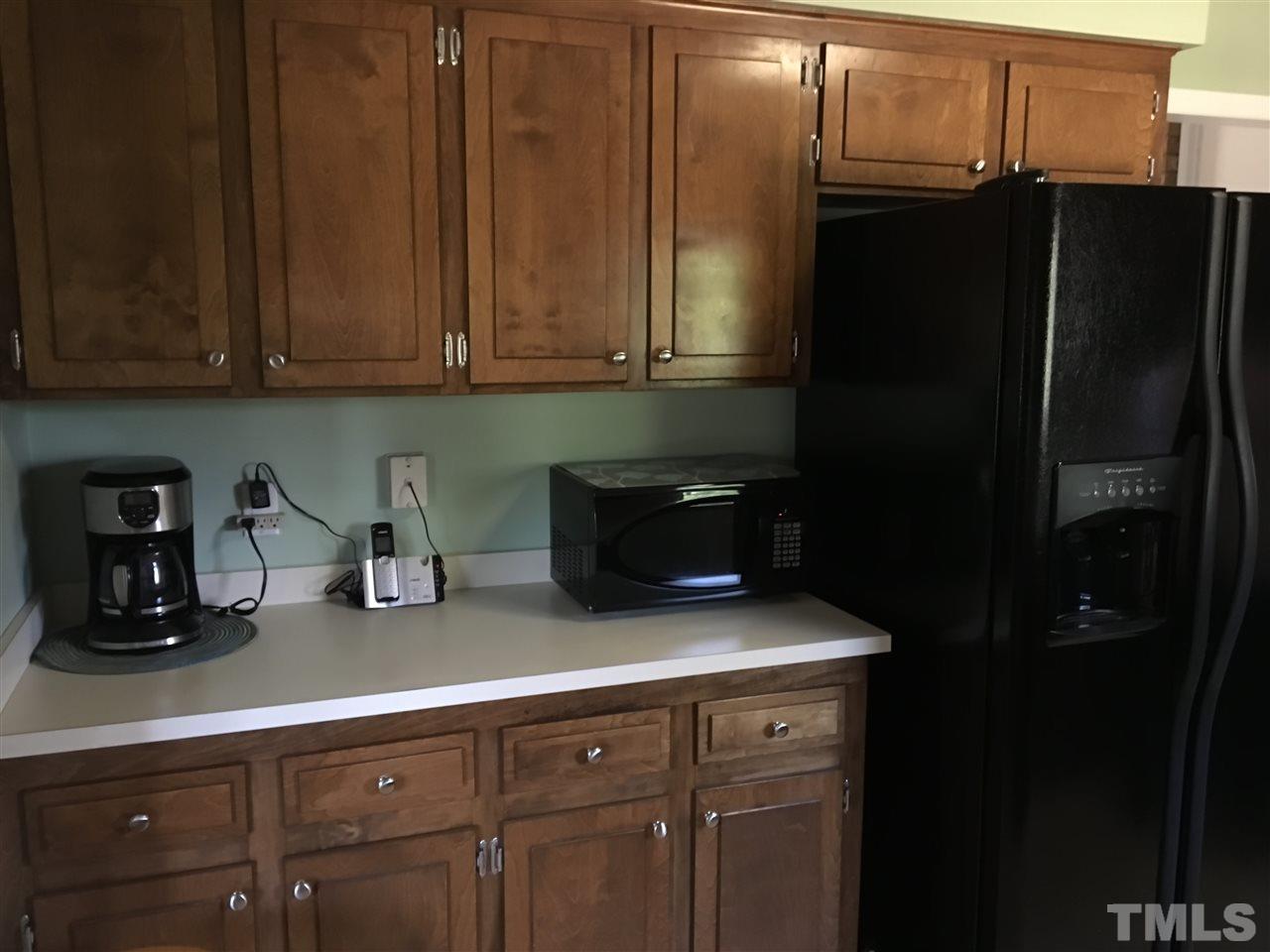 10101 Joe Leach Road Raleigh, NC 27603 - Photo 9 of 15 a kitchen with a refrigerator and cabinets