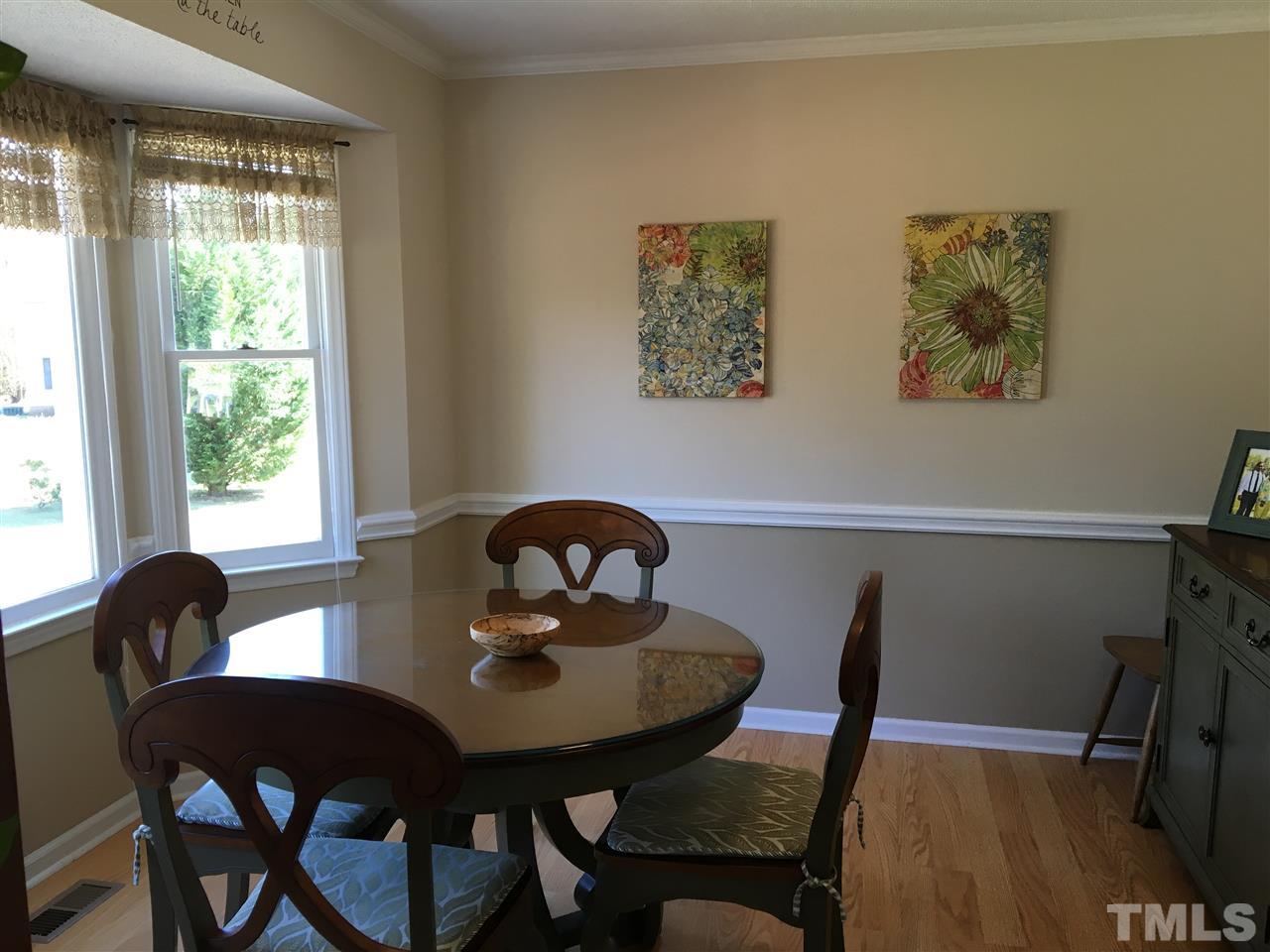 10101 Joe Leach Road Raleigh, NC 27603 - Photo 10 of 15 a view of a dining room with furniture and wooden floor
