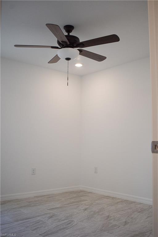 3880 Lora Street Fort Myers, FL 33916 - Photo 4 of 6 a view of an empty room with wooden floor