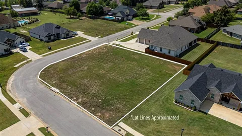 an aerial view of a pool a yard and chairs
