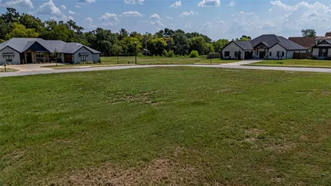 a view of a house with yard and a garden