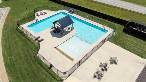 an aerial view of a house with garden space and street view