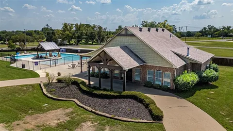 a view of a pool in a backyard