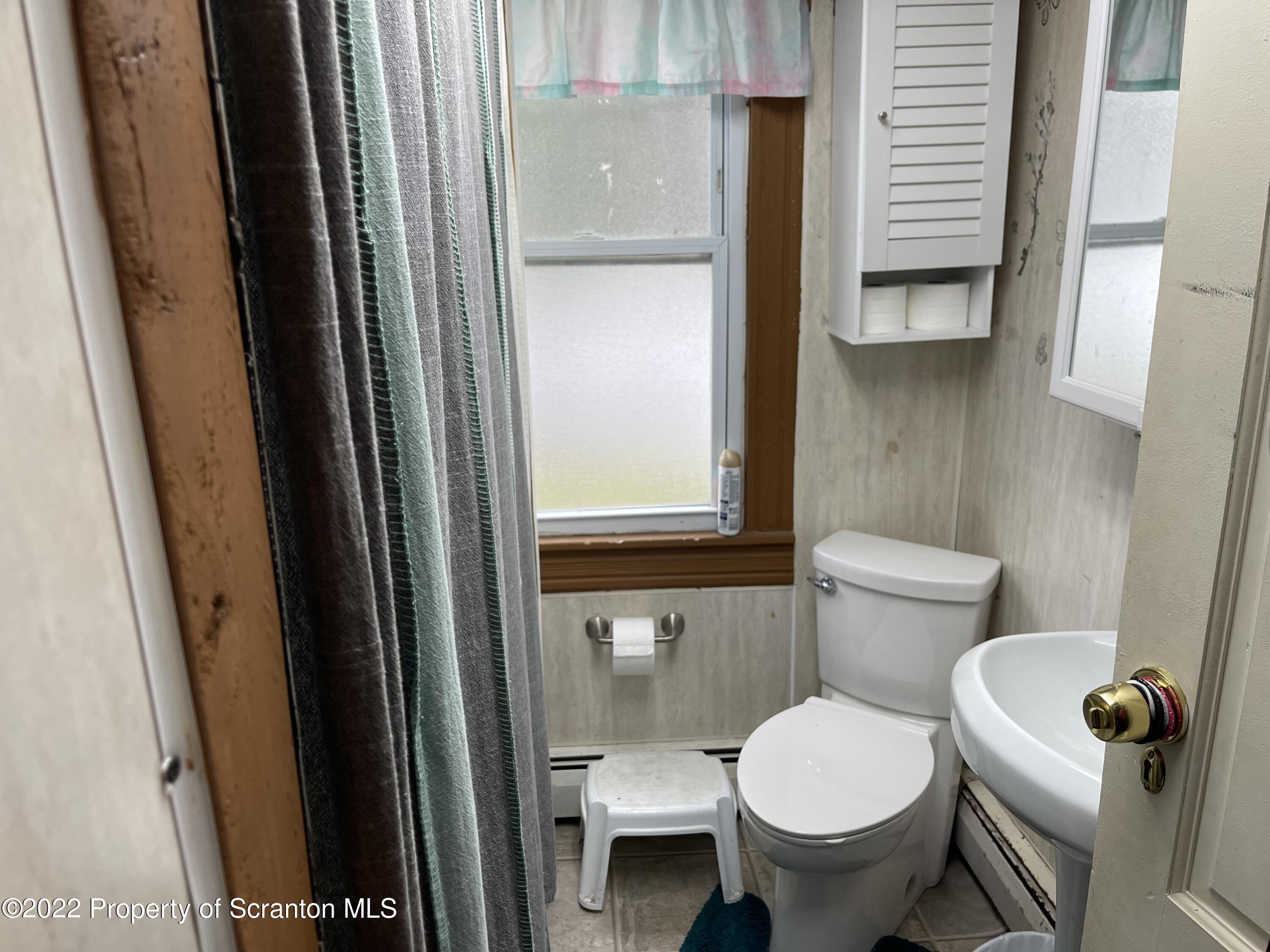 315 Aswell Court Scranton, PA 18504 - Photo 8 of 15 a white toilet sitting next to a bathroom sink