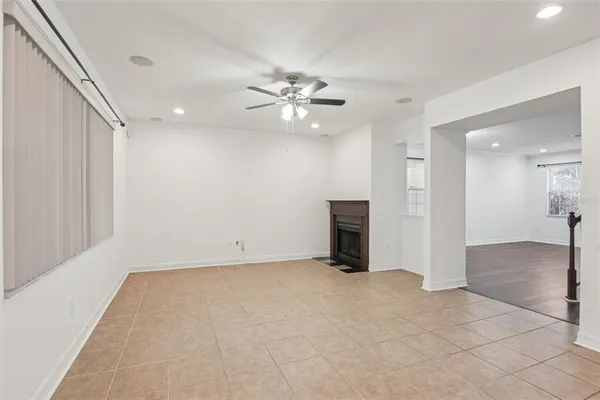 a view of an empty room with a ceiling fan