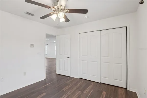 a view of an empty room and wooden floor